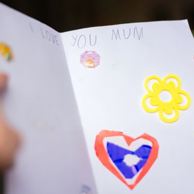 Child’s hands holding card for Mother’s day