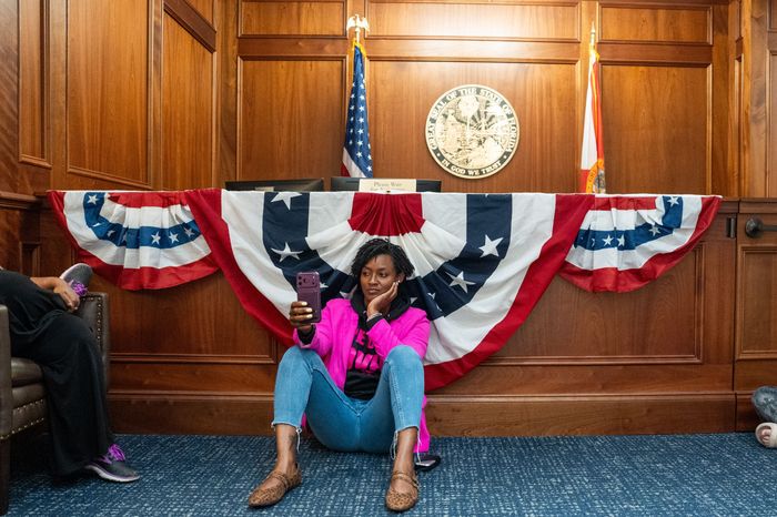 Rep. Angie Nixon sits on the floor of the Florida Governorís office while answering questions on an Instagram live feed Friday,