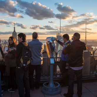 Rockefeller Center vantage point full of tourists at sunset