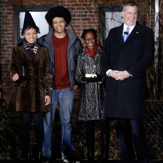 Bill de Blasio, right, laughs with his family, Chiara de Blasio, left, Dante de Blasio, second from left, and Chirlane McCray before being sworn in as the mayor of New York City at the start of the new year, Wednesday, Jan. 1, 2014 in New York. De Blasio took the oath of office moments after midnight at his home in Park Slope, Brooklyn. His inauguration will be celebrated at noon Wednesday, January 1, 2014 on the steps of City Hall when he takes the oath again, which will be administered by former US president Bill Clinton.