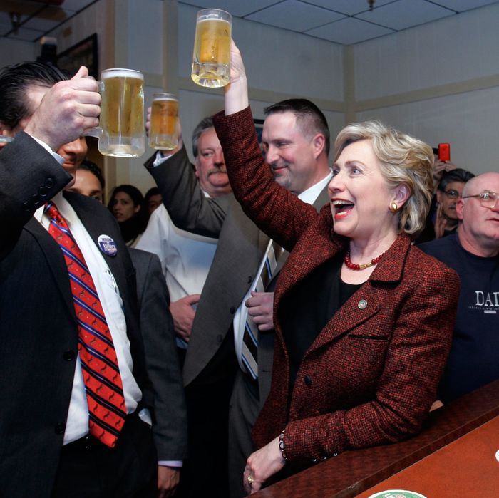 12 Apr 2008, USA --- Democratic presidential hopeful, Sen. Hillary Rodham Clinton, D-N.Y., raises her mug of beer in a toast with Hammond, Ind., Mayor Tom McDermott, left, as she stops at the bar during a campaign stop at Bronko's restaurant in Crown Point, Ind., Saturday, April 12, 2008. 
