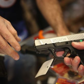 TINLEY PARK, IL - DECEMBER 17: A customer shops for a pistol at Freddie Bear Sports sporting goods store on December 17, 2012 in Tinley Park, Illinois. Americans purchased a record number of guns of guns in 2012. Gun sales have surged recently with people buy guns for personal protection following the mass shooting in Connecticut and gun enthusiasts buying guns because they fear a reinstatement of the assault weapons ban. About 47 percent of Americans own guns. (Photo by Scott Olson/Getty Images)