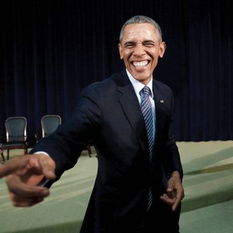 U.S. President Barack Obama reacts while greeting members of the audience after speaking at the Chief of Missions Conference at the State Department in Washington