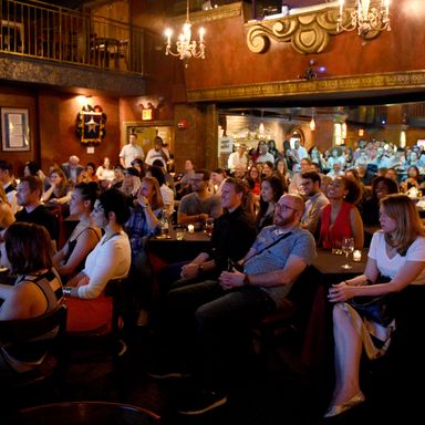 A packed house watches clips from the show.