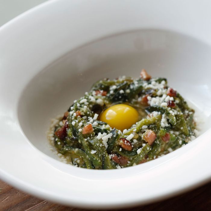Poblano-pepper carbonara with quail egg, Pecorino cheese, and bacon.
