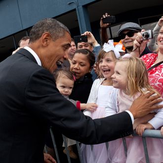 In this handout provided by the White House, President Barack Obama greets children upon arrival September 25, 2011 in Seattle, Washington.