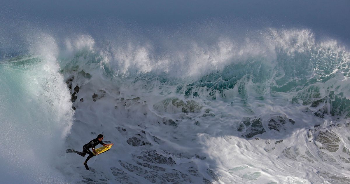 Surfers Tackle 20-Foot Waves While You Sit Inside Reading This