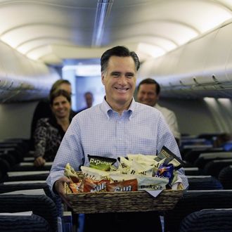 JACKSONVILLE, FL - JANUARY 30: Republican presidential candidate and former Massachusetts Gov. Mitt Romney carries snacks to reporters on his plane at the Jacksonville International airport before flying to St. Petersburg, Florida on January 30, 2012 in Jacksonville, Florida. Romney is campaigning across the state ahead of the January 31 Florida primary. (Photo by Joe Raedle/Getty Images)