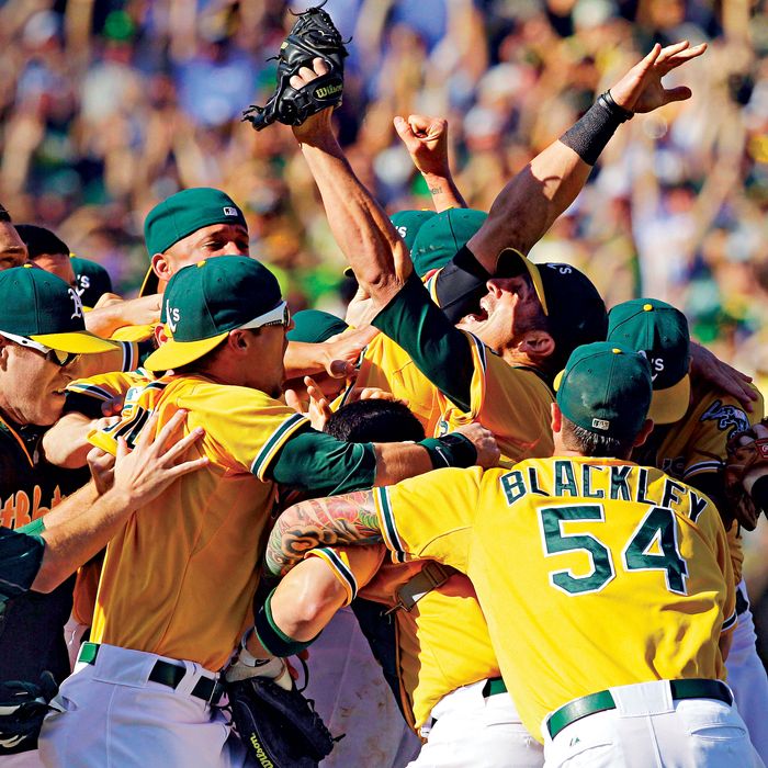 Oakland Athletics relief pitcher Grant Balfour, third right looking, up celebrates with teammates after their 12-5 win over the Texas Rangers in a baseball game, Wednesday, Oct. 3, 2012 in Oakland, Calif. The A's clinch the AL West title with the win. (AP Photo/Ben Margot)