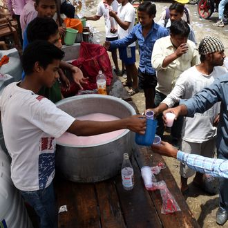 Indian volunteers distribute free cold sweet water on a street in New Delhi.