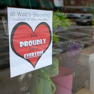 A window sign on a downtown Indianapolis florist, Wednesday, March 25, 2015, shows it's objection to the Religious Freedom bill passed by the Indiana legislature. Organizers of a major gamers' convention and a large church gathering say they're considering moving events from Indianapolis over a bill that critics say could legalize discrimination against gays. (AP Photo/Michael Conroy)