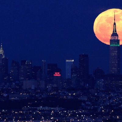 A full moon rises behind the Empire State Building in New York in this view from Eagle Rock Reservation in West Orange, N.J., in this April 6, 2012 file photo. The biggest and brightest full moon of the year arrives Saturday night May 5, 2012 as our celestial neighbor passes closer to Earth than usual. Saturday's event is a 