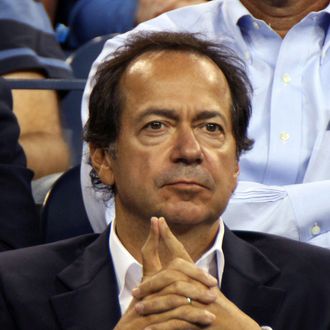John Paulson, president and co-fund manager of Paulson & Co. Inc., attends a tennis match during U.S. Open at the Billie Jean King National Tennis Center in New York, U.S., on Tuesday, Aug. 30, 2011. Paulson and his wife, Jenny, had planned to host a fund-raiser for Republican presidential hopeful Mitt Romney at their estate in Southampton on Sunday but it was postponed due to Hurricane Irene, according to Wall Street Journal. Photographer: Rick Maiman/Bloomberg via Getty Images