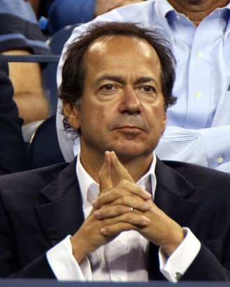 John Paulson, president and co-fund manager of Paulson & Co. Inc., attends a tennis match during U.S. Open at the Billie Jean King National Tennis Center in New York, U.S., on Tuesday, Aug. 30, 2011. Paulson and his wife, Jenny, had planned to host a fund-raiser for Republican presidential hopeful Mitt Romney at their estate in Southampton on Sunday but it was postponed due to Hurricane Irene, according to Wall Street Journal. Photographer: Rick Maiman/Bloomberg via Getty Images