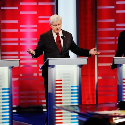 DES MOINES, IA - DECEMBER 10: Former speaker of the House Newt Gingrich (C) speaks while former Massachusetts Gov. Mitt Romney (L) and U.S. Rep. Ron Paul (R-TX) look on during th ABC News GOP Presidential debate on the campus of Drake University on December 10, 2011 in Des Moines, Iowa. Rivals were expected to target front runner Gingrich in the debate hosted by ABC News, Yahoo News, WOI-TV, The Des Moines Register and the Iowa GOP. (Photo by Kevork Djansezian/Getty Images)