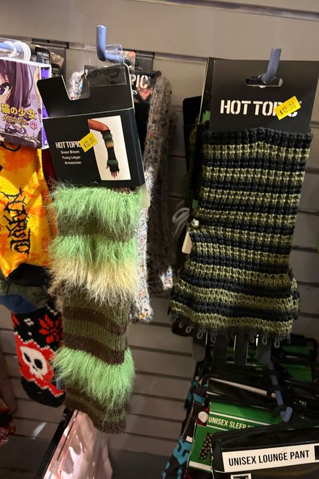 Some armwarmers, one fuzzy and striped, one knitted. 