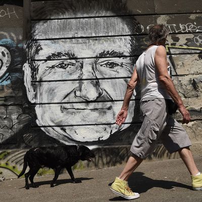 A man with his dog walk past a mural depicting actor Robin Williams in downtown Belgrade on August 13, 2014. Unknown artists drew the Academy Award-winning actor and comedian below a Belgrade bridge to pay a tribute following the news that he had been found dead of an apparent suicide at the age of 63. A man with his dog walk past a mural depicting actor Robin Williams in downtown Belgrade on August 13, 2014. Unknown artists drew the Academy Award-winning actor and comedian below a Belgrade bridge to pay a tribute following the news that he had been found dead of an apparent suicide at the age of 63. AFP PHOTO / ANDREJ ISAKOVIC (Photo credit should read ANDREJ ISAKOVIC/AFP/Getty Images)