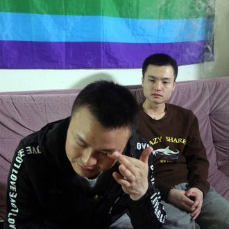 In this photo taken Tuesday, April 12, 2016, Sun Wenlin, right, sits with his partner Hu Mingliang at home a day before going to court to argue in China's first gay marriage case in Changsha in central China's Hunan province. A judge on Wednesday, April 13, 2016 ruled against the gay couple in China's first same-sex marriage case that attracted several hundred cheering supporters to the courthouse and was seen as a landmark moment for the country's emerging LGBT rights movement. (AP Photo/Gerry Shih)