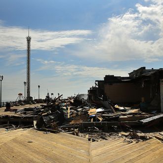 SEASIDE HEIGHTS, NJ - SEPTEMBER 13: The scene of a massive fire that destroyed dozens of businesses is viewed along an iconic Jersey shore boardwalk on September 13, 2013 in Seaside Heights, New Jersey. The 6-alarm fire began in a frozen custard stand on the recently rebuilt boardwalk around 2:30 p.m. and quickly spread in high winds. While there were no injuries reported, many businesses that had only recently re-opened after Hurricane Sandy were destroyed in the blaze. (Photo by Spencer Platt/Getty Images)