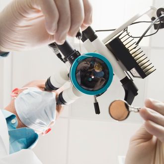 Lowe angle view of dentist using microscope