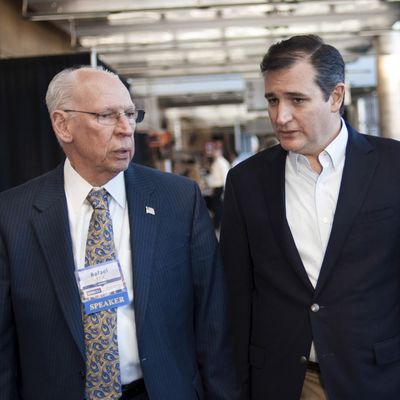 U.S. Republican presidential candidate Cruz speaks with his father at the Freedom 2015 Conference in Des Moines, Iowa