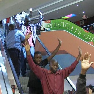 An image grab taken from AFP TV shows civilians being evacuated from a shopping mall following an attack by masked gunmen in Nairobi on September 21, 2013. Masked attackers stormed the packed upmarket shopping mall in Nairobi, spraying gunfire and killing at least 59 people and wounding 175 before holing themselves up in the complex. 