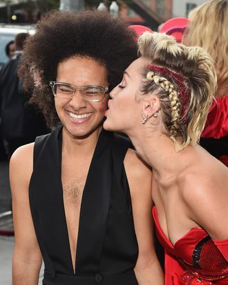 Miley Cyrus with her date, Tyler Ford, at the AmFar Inspiration Gala. 