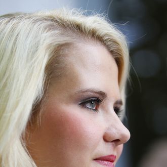 SALT LAKE CITY, UT - MAY 25: Elizabeth Smart listens to her father Ed Smart talk to the press after a hearing for the sentencing of her kidnapper Brian David Mitchell May 25, 2011 in Salt Lake City, Utah. Mitchell was sentences to life in prison. Mitchell was sentenced to life for the kidnapping of Elizabeth Smart in 2002. (Photo by George Frey/Getty Images)