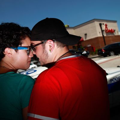 DALLAS, TX - AUGUST 03: (L-R) Same sex couple Whitney Copeland and Skye Newkirk embrace outside a Chick-fil-A restaurant on August 3, 2012 in Dallas, Texas. Several same sex couples gathered to kiss in support of a National Same Sex Kiss Day at Chick-fil-A held across the country in response to Chick-fil-A's stance on gay marriage. (Photo by Tom Pennington/Getty Images)