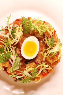 Hand-cut salmon tartare, fried capers, roasted peppers, soft-boiled quail egg.