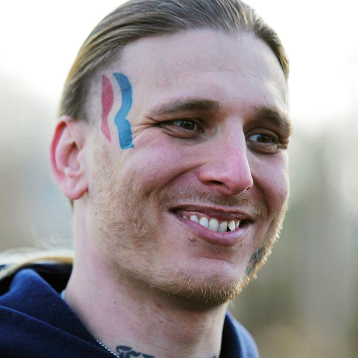 Eric Hartsburg, 30, poses for a photo showing his Romney-Ryan election logo tattoo Friday, Nov. 30, 2012 in Michigan City, Ind. Hartsburg, a professional wrestler, said he hoped the 5-by-2-inch tattoo would make politics more fun and had initially resigned himself to keeping it, but he is now planning to have it removed. (AP Photo/Teresa Crawford)