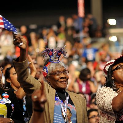 Chaz Rodgees, left, Myrtis Evans, center, and Addie D. Allen, delegates from Texas, cheer during day two of the Democratic National Convention (DNC) in Charlotte, North Carolina, U.S., on Wednesday, Sept. 5, 2012. Democratic officials have moved President Barack Obama's nomination acceptance speech tomorrow night to the Time Warner Cable Arena from the larger, outdoor Bank of America Stadium because of the possibility of severe weather.
