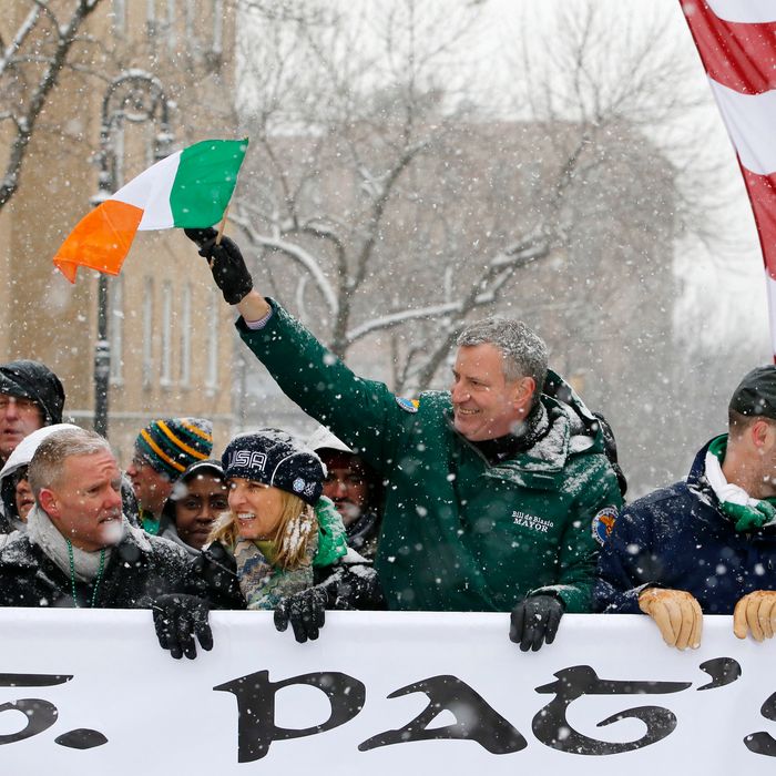 New York Mayor Bill de Blasio, center, waves the flag of Ireland as he marches beside Kerry Kennedy, third from left, during the all-inclusive St. Pat's For All parade in the Sunnyside, Queens neighborhood of New York, Sunday, March 1, 2015. The St. Pat's For All parade, which embraces diversity and inclusion, is considered an alternative to the New York City's official St. Patrick's Day parade on March 17. (AP Photo/Kathy Willens)