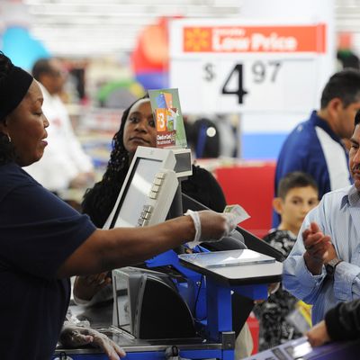 An employee rings up sales at a cash register at a Walmart in the Crenshaw district of Los Angeles on Black Friday, November 29, 2013. US stocks Friday moved higher in a holiday-shortened session following better eurozone economic data and positive early assessments of 