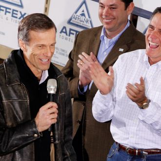 Sen John Thune (R-SD) (L) gets a laugh and applause from former Massachusetts Gov. and Republican presidential candidate Mitt Romney (R) and Rep. Jason Chaffetz (R-UT) during a rally at the Weber Paper Company January 2, 2012 in Dubuque, Iowa. 