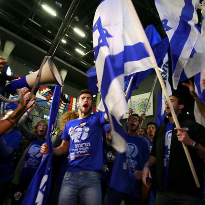 Supporters of the centre-left Zionist Union party take part in early celebrations outside the party's headquarters as they wait for the announcement of the first official results of the Israel's parliamentary elections on March 17, 2015 in the city of Tel Aviv. Israelis voted in a close-fought election pitting the centre left against Prime Minister Benjamin Netanyahu who is fighting for his political survival after six years in power. AFP PHOTO / GALI TIBBON (Photo credit should read GALI TIBBON/AFP/Getty Images)