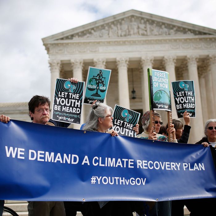 Protesters attend a rally outside the U.S. Supreme Court held by the group Our Children’s Trust October 29, 2018 in Washington, DC. The group rallied in support of the Juliana v. U.S. lawsuit brought on behalf of 21 youth plaintiffs that argues the U.S. government has violated constitutional rights for more than 50 years by contributing to climate change.