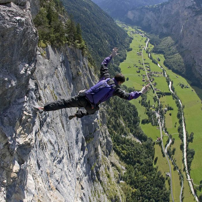Dean Potter executes a free solo climb and fall with parchute in summer 2008 at Lauterbrunnen in Switzerland.