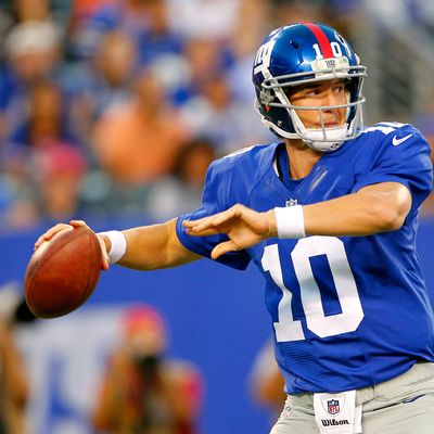 Eli Manning #10 of the New York Giants looks to pass the New England Patriots during an NFL pre-season game at MetLife Stadium on August 29, 2012 in East Rutherford, New Jersey. 