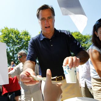 Republican presidential candidate Mitt Romney and Sen. Kelly Ayotte, R-N.H. buy lemonade as they walk in the Fourth of July Parade in Wolfeboro, N.H., Wednesday, July 4, 2012.