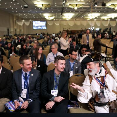 Dressed in American revolutionary clothing, William Temple (R) of Brunswick, Georgia visits with students (L-R) Nicholas Blincoe, Matthew Leahy and Elliot Brietta of Scottsdale, AZ, during the second day of the Conservative Political Action Conference at the Gaylord International Hotel and Conference Center March 7, 2014 in National Harbor, Maryland. The CPAC annual meeting brings together conservative politicians, pundits and their supporters for speeches, panels and classes. 