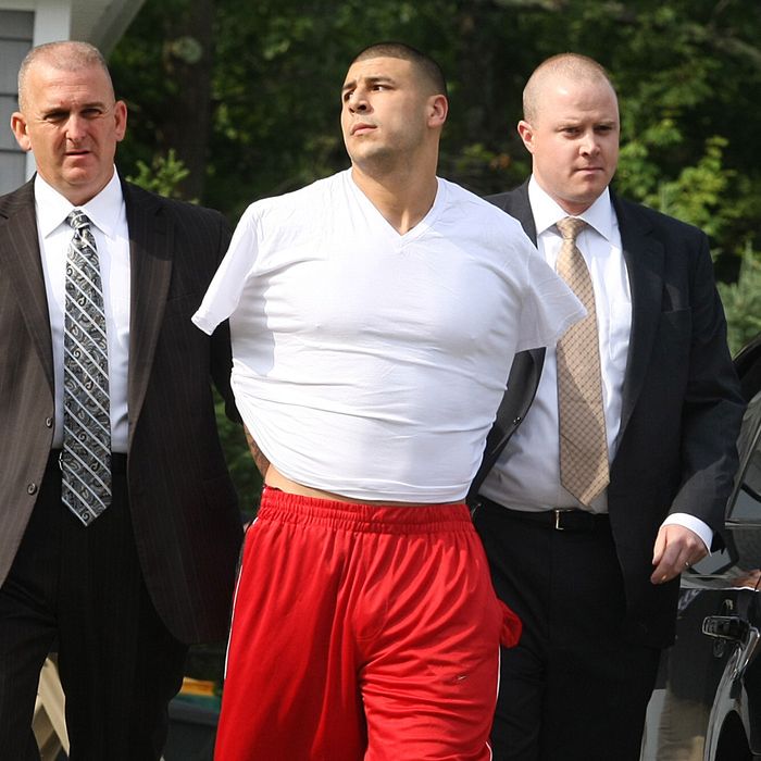 NORTH ATTLEBOROUGH, MA - JUNE 25: New England Patriots tight end Aaron Hernandez was arrested and led out of his home in handcuffs, shortly before 9 a.m. It is not immediately known what charges he is facing, but he has been under investigation in connection with the murder of Odin Lloyd. (Photo by George Rizer for The Boston Globe via Getty Images)