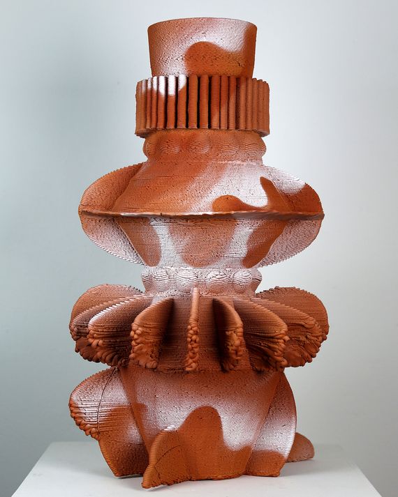 A geometric 3-D printed tower made from terra cotta with an airbrushed white glaze