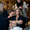 Hannah Neeleman, last year's Mrs. American pageant winner, holds her newborn daughter, Flora Jo, as she gets ready for the Mrs. World beauty pageant at the Westgate Hotel and Casino in Las Vegas, Jan. 19, 2024. (Bridget Bennett/The New York Times)