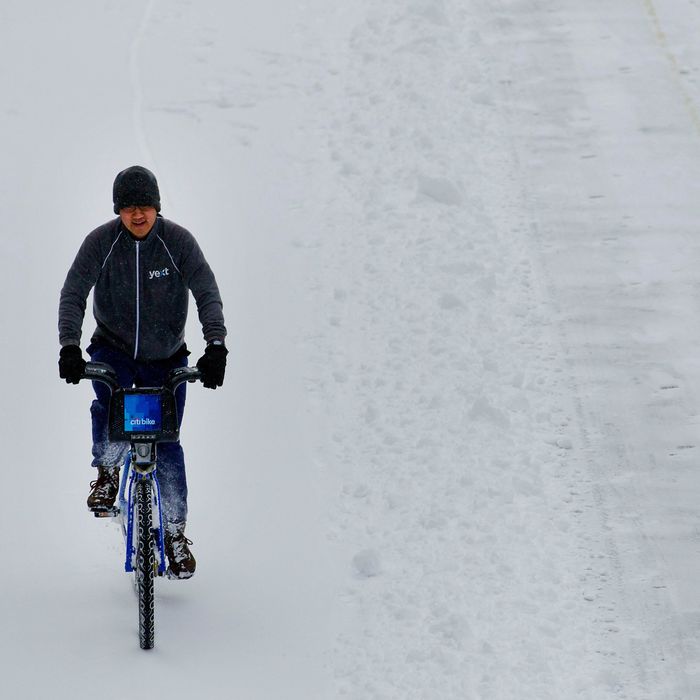 A bicyclist rides a Citi Bike through the snow in New York, U.S., on Friday, Jan. 3, 2014.