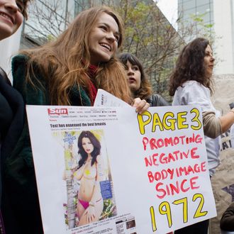 Feminist campaigners protest outside the UK offices of News International in east London on November 17, 2012 against the continued use of topless photographs of women on page 3 of 