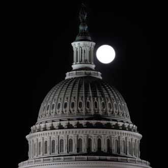 The full moon rises behind the U.S. Capitol Dome in Washington March 19, 2011.