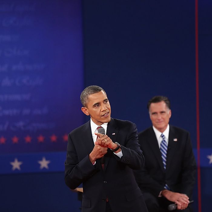 HEMPSTEAD, NY - OCTOBER 16: Republican presidential candidate Mitt Romney listens as U.S. President Barack Obama (L) answers a question during a town hall style debate at Hofstra University October 16, 2012 in Hempstead, New York. During the second of three presidential debates, the candidates fielded questions from audience members on a wide variety of issues. (Photo by Spencer Platt/Getty Images)