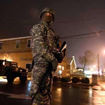 A National Guard trooper keeps vigil on a street near police station in Ferguson, Missouri, on November 26, 2014. 