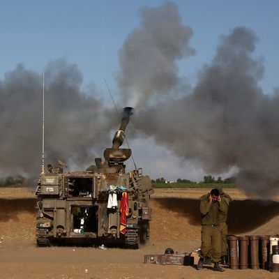 A 155mm artillery, positioned near the Israeli border with the Gaza Strip, fires a projectile towards targets in the Palestinian enclave, on July 17, 2014. Israel and the Islamist Hamas movement have agreed on a ceasefire that will begin at 0300 GMT on Friday, an Israeli official told AFP. AFP PHOTO /MENAHEM KAHANA (Photo credit should read MENAHEM KAHANA/AFP/Getty Images)